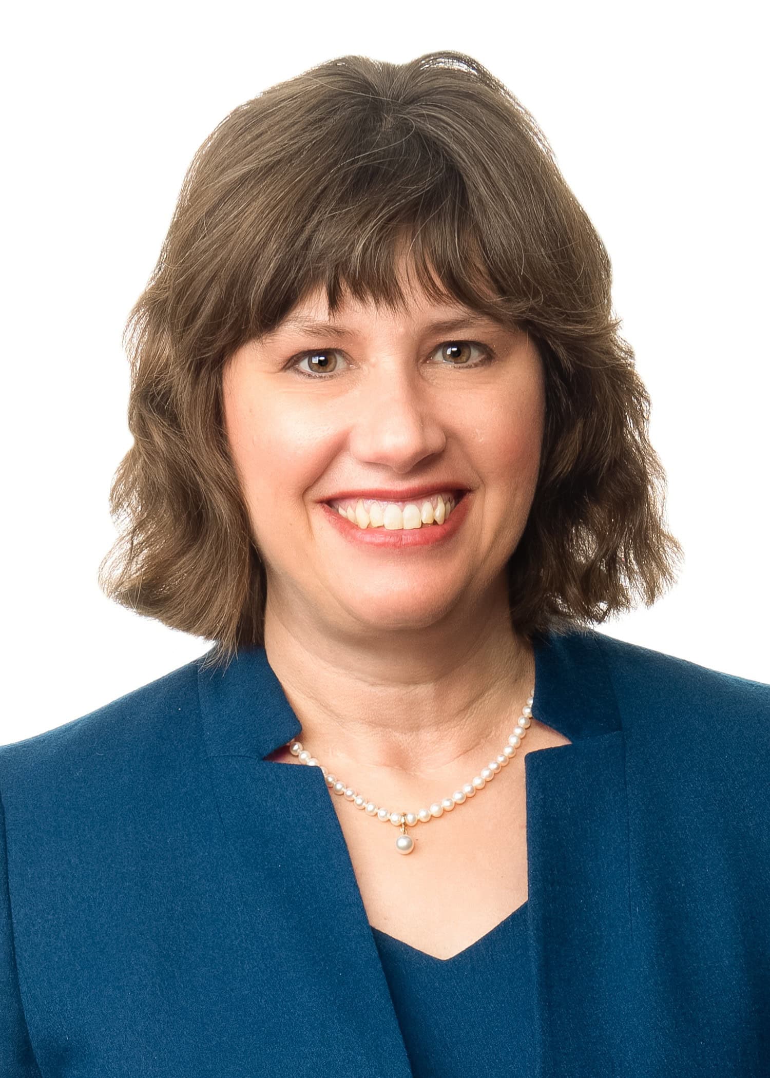 Volunteer spotlight: Irene Peterson, smiling in a blue blazer and pearl necklace.