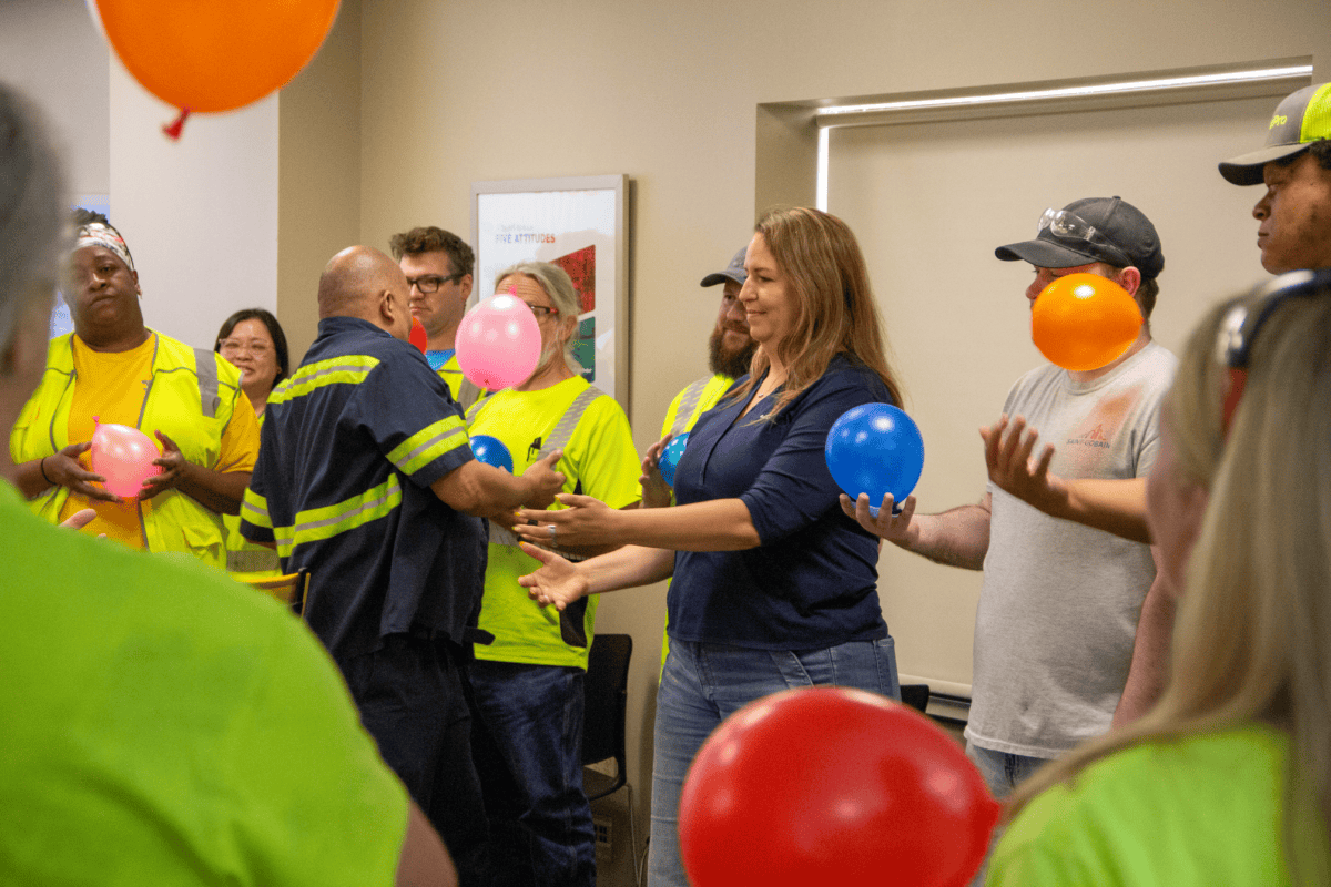 Technicians pass balloons in a workshop. Ceramics essentials training event.