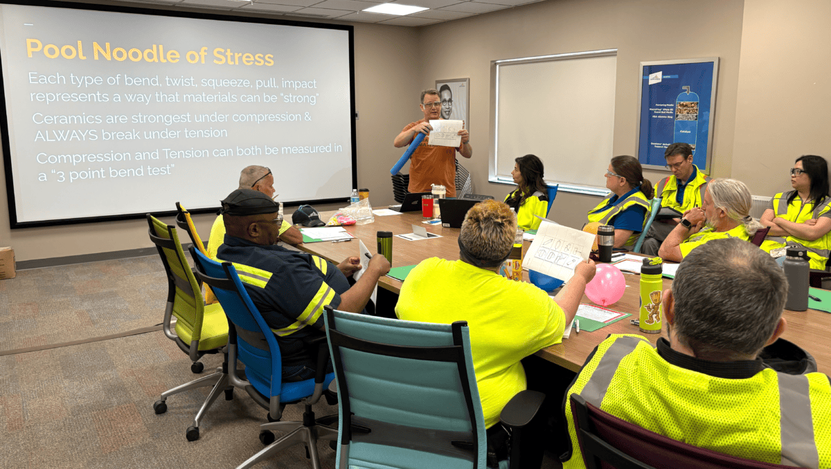 Technician workshop: Instructor demonstrates "Pool Noodle of Stress" concept for ceramics essentials training.
