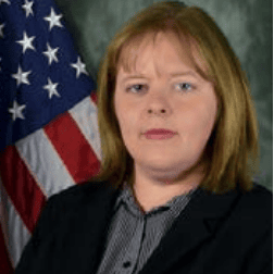 Official portrait of a woman in front of the American flag.