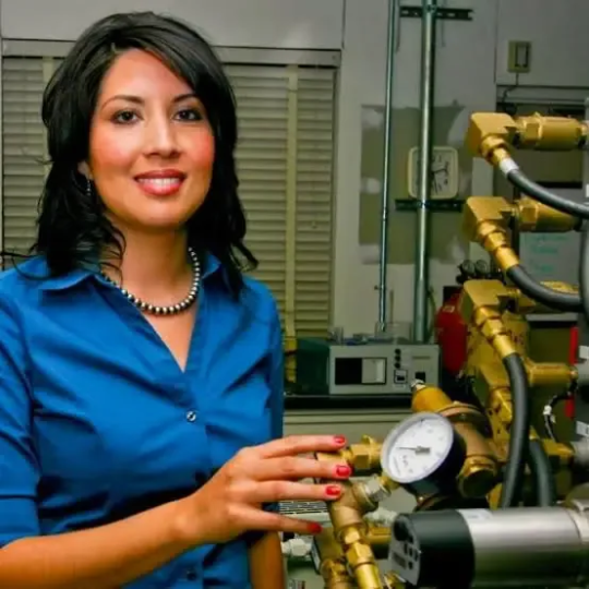 Engineer in lab, inspecting materials testing equipment.